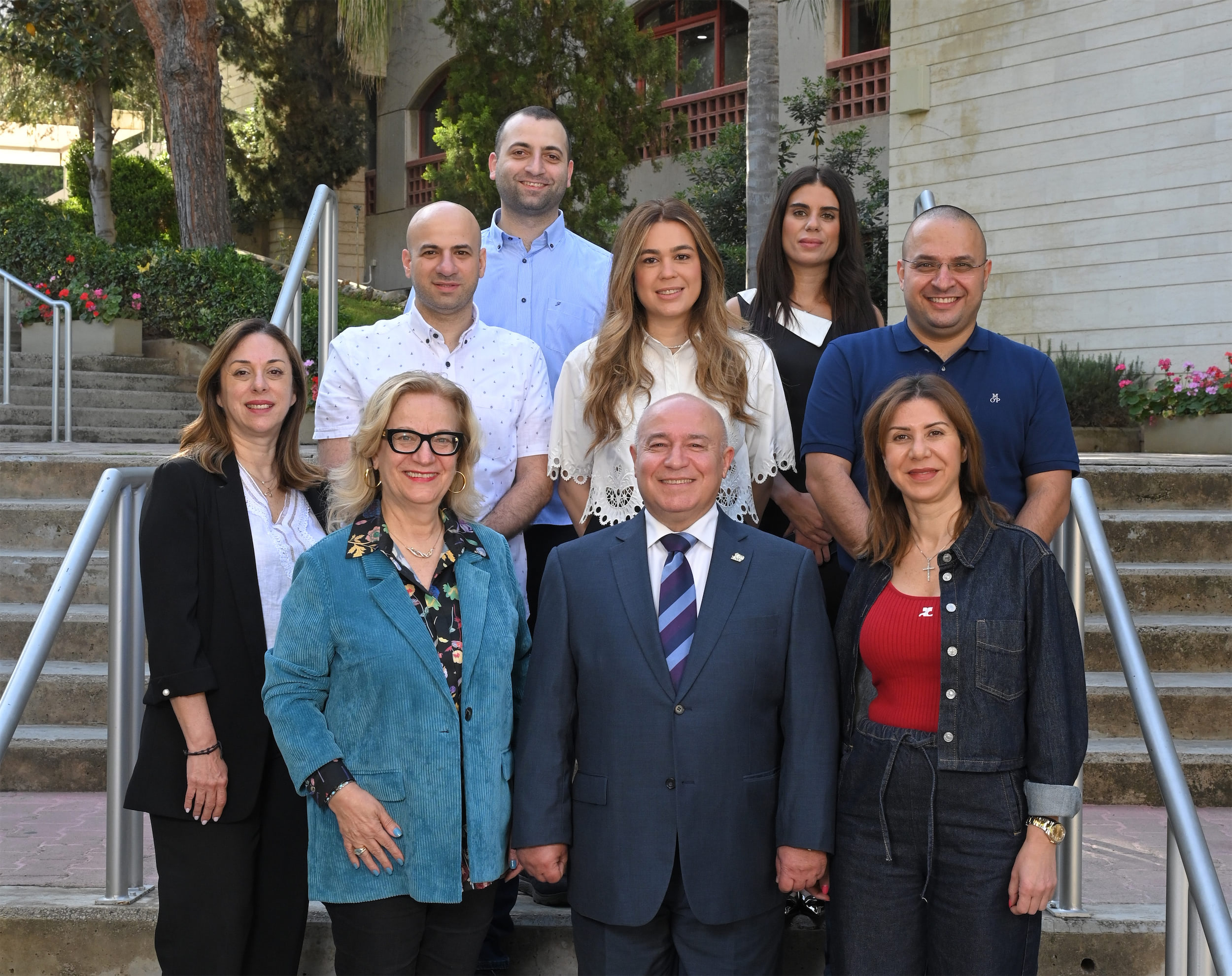 Byblos team standing on the stairs next to Architecture Hall